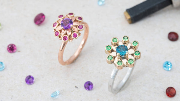 Elegant flower-design rings with colorful gemstones for optimization consultants.