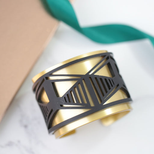 “Gold and black geometric cuff bracelet for optimisation consultant.